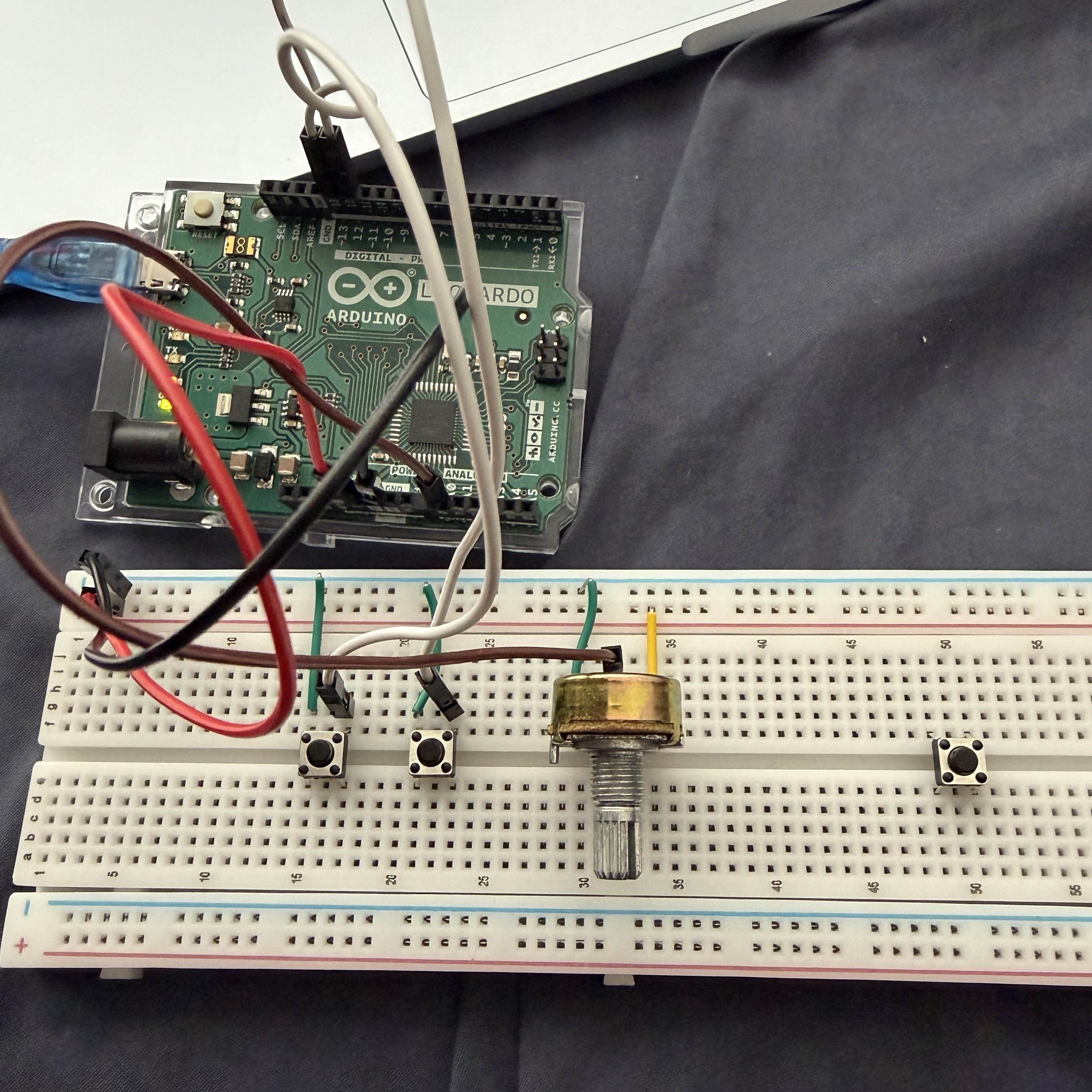 Breadboard test setup with 2 button and one potentiometer connected for MIDI output experiments.