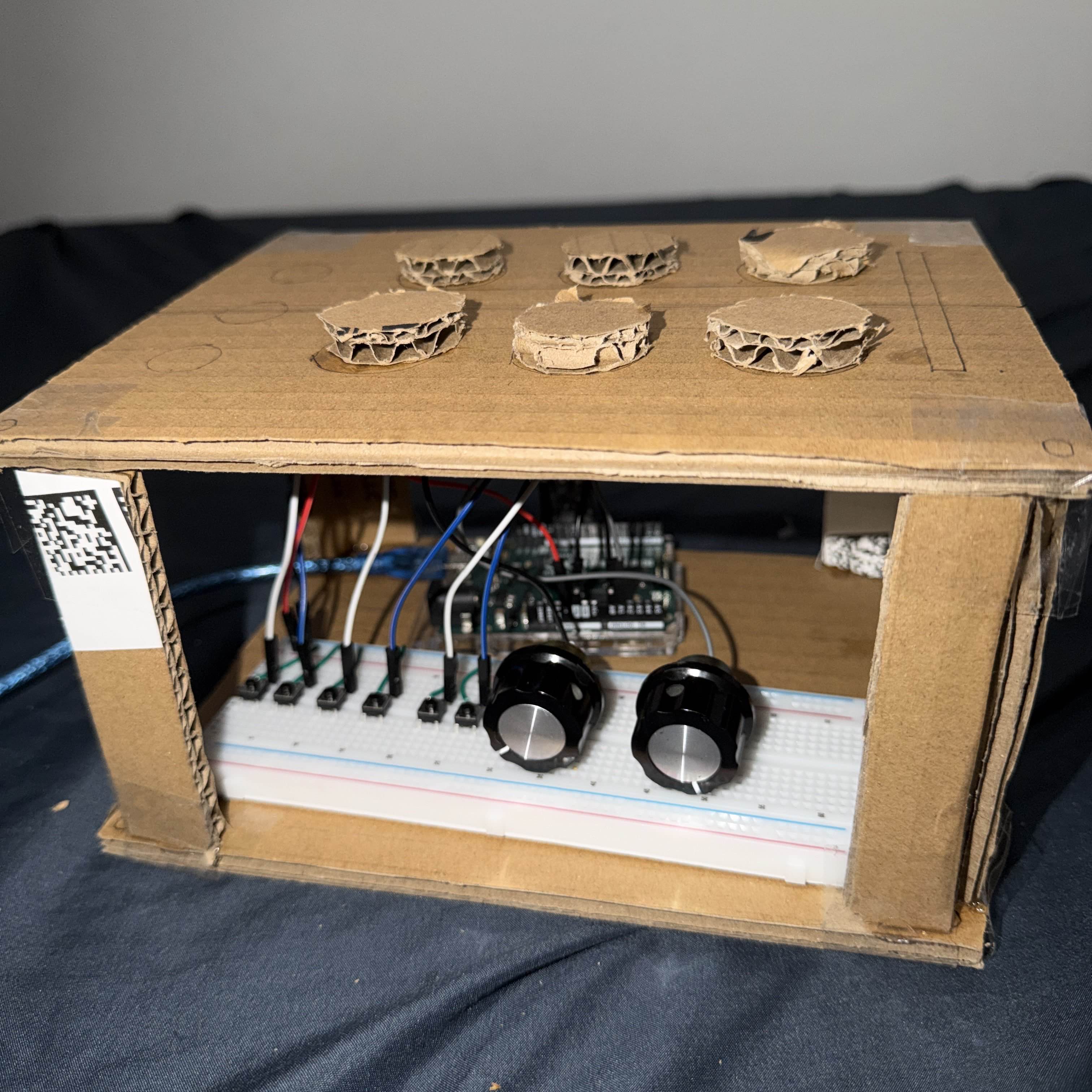 Internal view of the prototype showing space for wiring, potentiometers, and the microcontroller underneath the top panel.